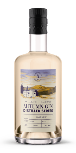 A clear glass bottle filled with a light yellow gin. A label on the front saying "Autumn Gin, Distiller Series" with imagery of a caravan overlooking an inlet and mountain in the distance with pastel yellow and purple tones